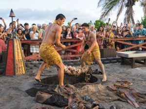 Guests crowded around the pit as it is opened in the late light
